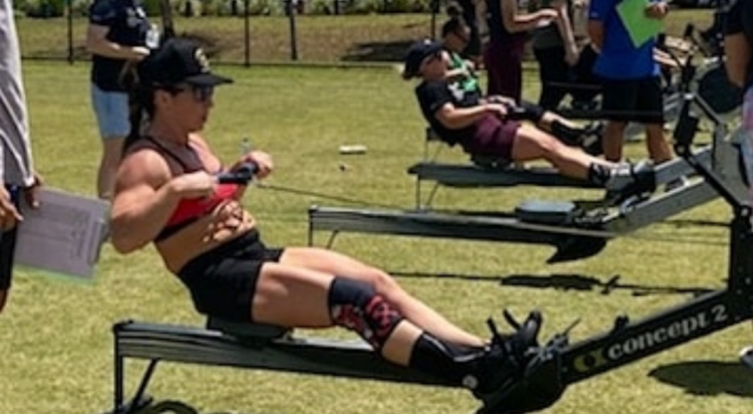 Naomi Lewin on a Concept2 rower at a competition