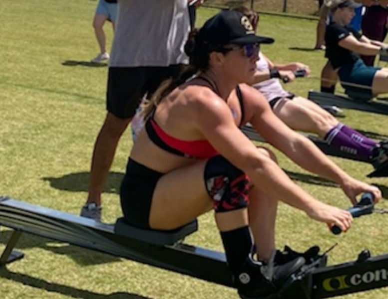 Naomi Lewin rowing at a fitness competition